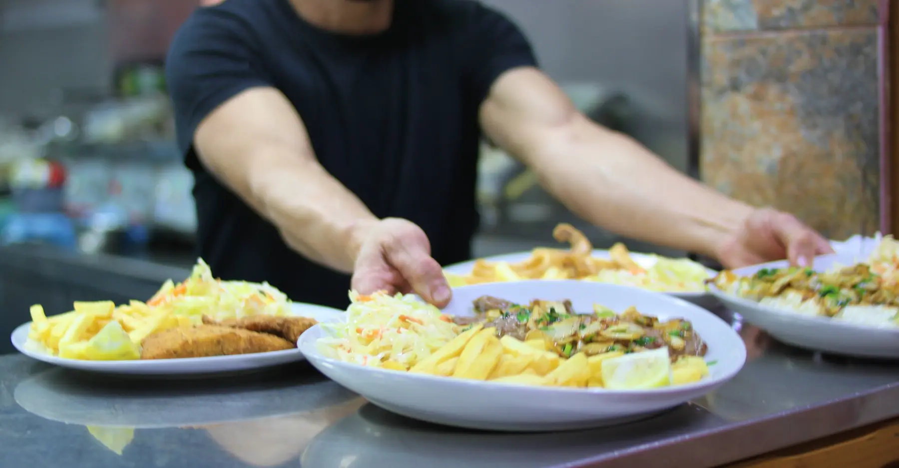 Platos recién preparados saliendo de la cocina de Pizzería 12-34
